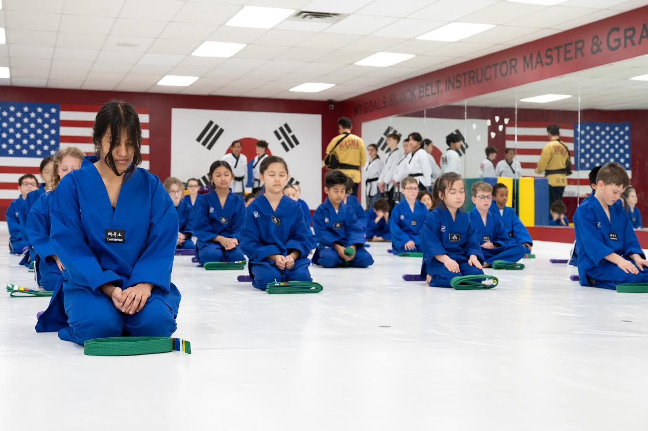 Students meditating in dojo